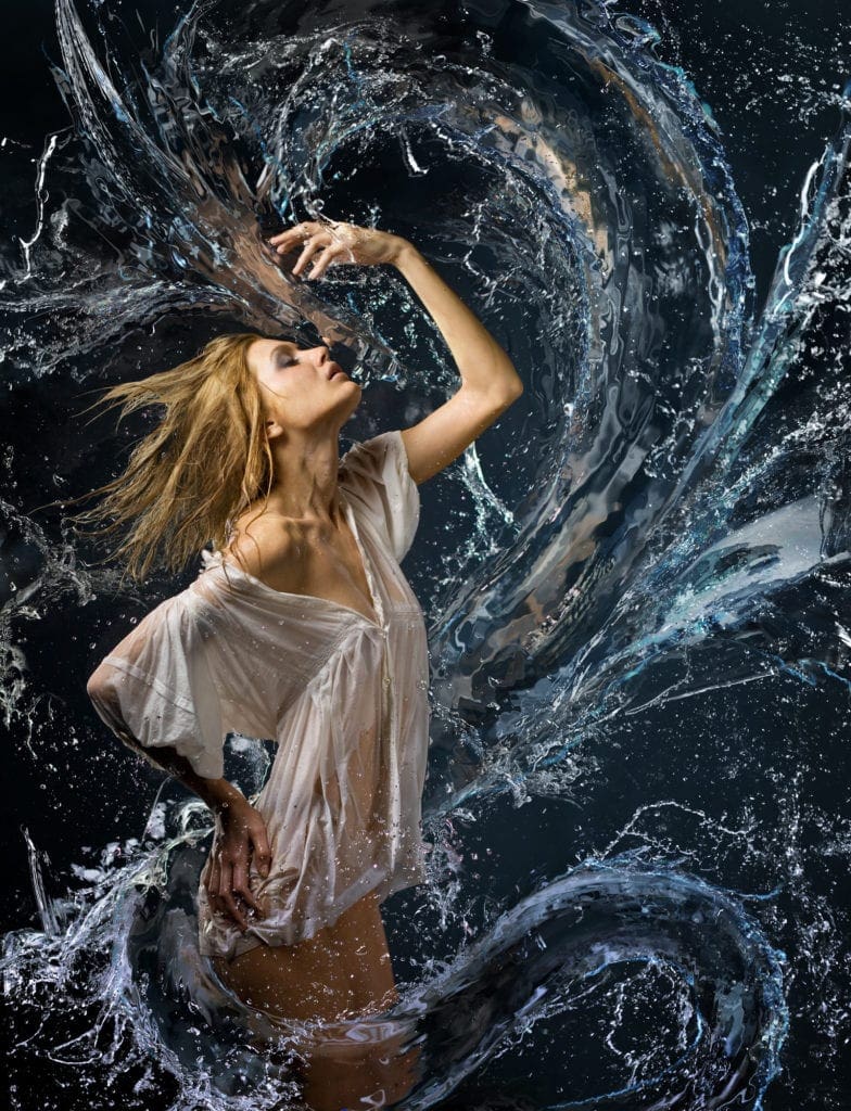 beautiful girl in a wet white shirt and a water dragon
