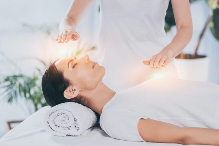 Reiki healing session with practitioner and client